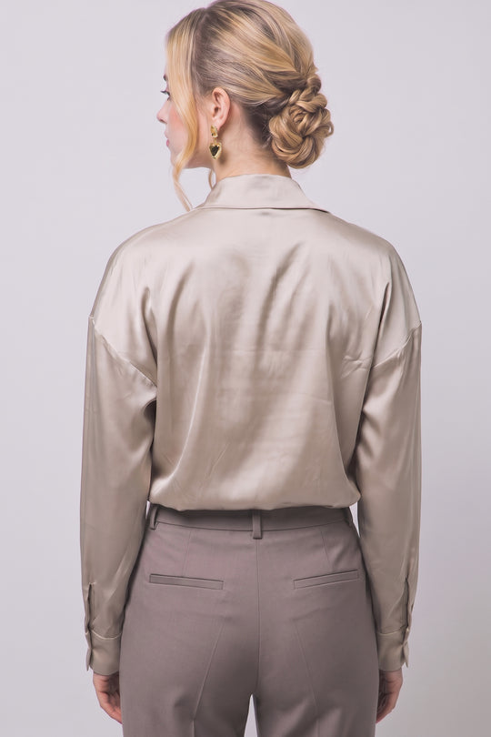 Pantiblusa estilo camisa satinada en tono perla/champán, diseñada para brindar un ajuste elegante y estilizado.